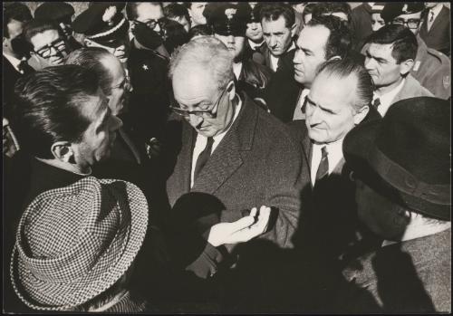 President of the Republic Giuseppe Saragat talks to other officials, uniformed police and displaced residents in Sicily after the Belice earthquake, 1968
