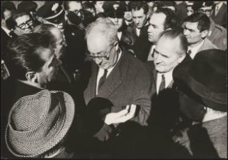 President of the Republic Giuseppe Saragat talks to other officials, uniformed police and displaced residents in Sicily after the Belice earthquake, 1968