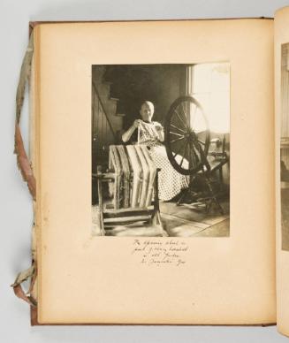 The spinning wheel is part of every household in old Quebec. In Yamoski, Que. [Page 41 of Quebec I; from collection of Canadian albums compiled by Edith S. Watson, 1890s-1930s]