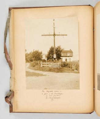 The wayside cross is a part of the landscape in old Quebec. In Caughonegue [sic] [Caughnawaga/Kahnawake], Que.[Page 18 of Quebec I; from collection of Canadian albums compiled by Edith S. Watson, 1890s-1930s]