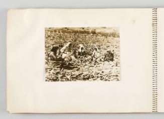 [Women and children sitting in a semicircle on farmland, page 22 of The Doukhobors I album]