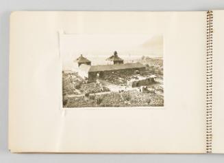 [Image of long building with laundry hung out back, taken from high point, page 2 of The Doukhobors I album]