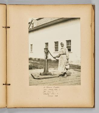 A Russian Doukhobor lops drawing water in the yard of a "Community" home in Verigin, Sask. [Page 19 of Wells and Pots album]
