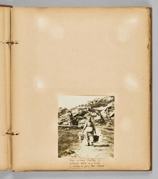 Inscribed at bottom of page recto: The curious custom of carrying water on a hoop in common in many Nfld. outports. [Page 13 of Wells and Pots album]