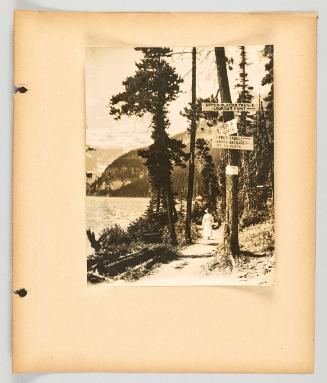 Trail signs on trees at Lake Louise. [Page 23 of Banff, Lake Louise album]