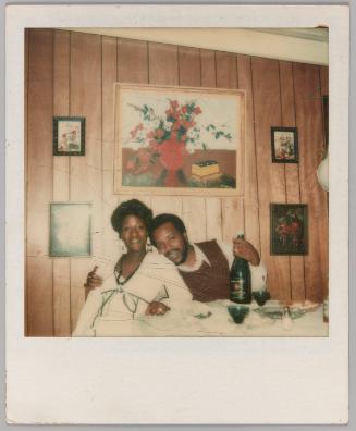 Our Mothers, 11-25-17 [Man and woman sitting in front of wood panelled wall, painting of red flower in background]