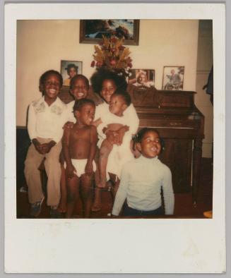 Troy, Nate, Jimmy, Me-Me, Sasha, Shana [Six children posing in front of piano]
