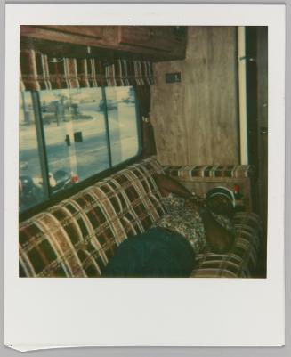[Man sleeping on couch in RV]
