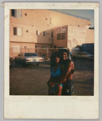 [Man and woman embracing outside Annie's Chili Hut]
