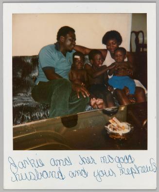 Jackie and her no good husband and your nephews [Man and woman sitting on couch with three young boys]
