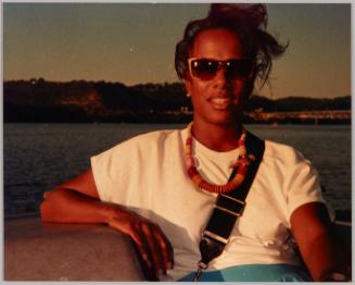 Renee on the river Pgh 1989 [Woman in sunglasses and wood bead necklace by the water]