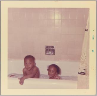 [Toddler boy and girl taking a bath]
