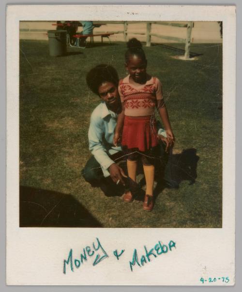 Money & Makeba 4-20-75 [Man sitting on grass with girl standing in front of him and wearing a pink top and skirt]