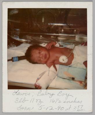 Lewis, Baby Boy 3 lb 11 oz 16 1/2 inches Born 5-12-90 at 3:57am [Newborn baby asleep in hospital bed]