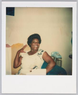 [Woman with a big smile posing with hand on hip]