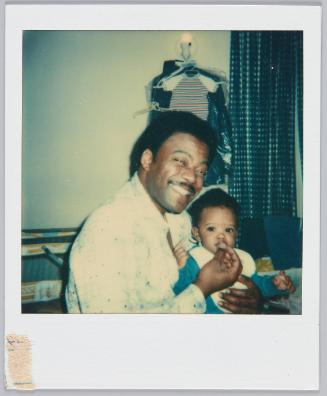 JD & Jay. Jay eating meat sitcks, 9 mos old, Sunday Evening