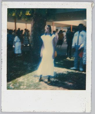 [Blurry image of adolescent girl in long white dress]
