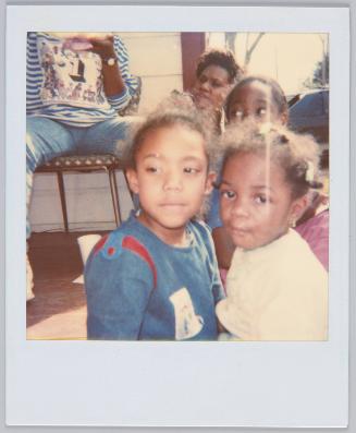 [Close up of two little girls, girl on left looks away from camera]