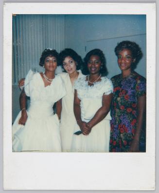 [Group of four women smiling, bride standing on far left]