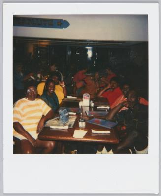 [Large group sitting at restaurant tables]