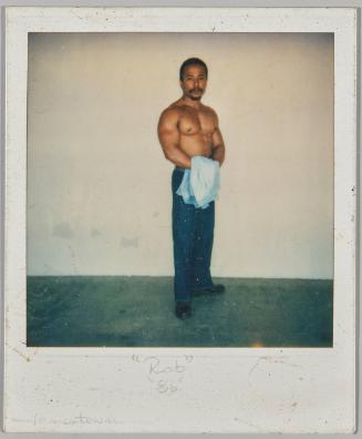 "Rob" "86" Jamestown [Shirtless man with moustache holding a blue shirt and standing in front of white wall]