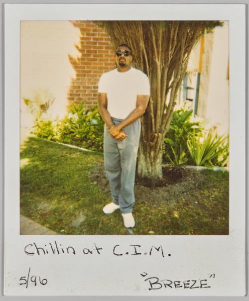 Chillin at C.I.M. "Breeze" 5/96 [Man in sunglasses standing in front of tree]
