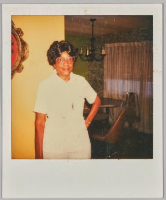 Shelma [Woman in white top and glasses posing with hand on her hip]
