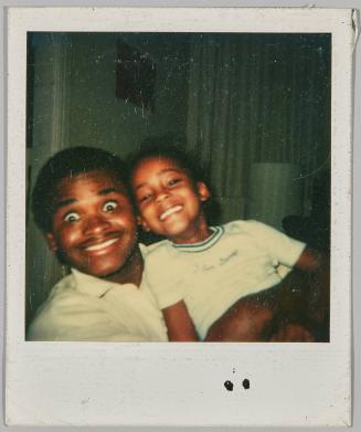 [Little girl smiling big with wide-eyed young man]
