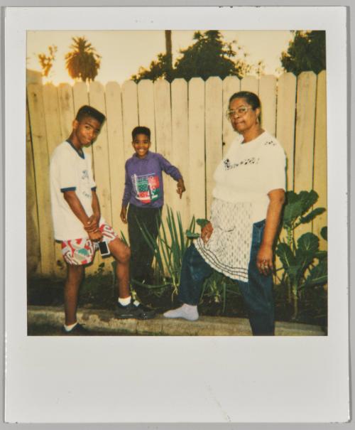 [Older woman posing in garden with young boys]
