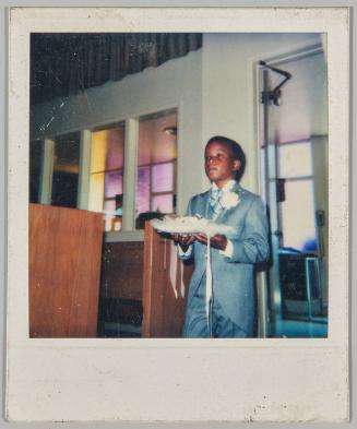 [Ring bearer waling down the aisle in grey suit]
