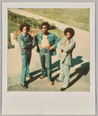 [Three men in denim and afros posing]
