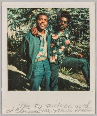 The T.V. picture used of Clarence for news media [Two men posing in florals and green]

