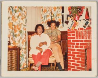 [Woman laughing with teenage girl seated next to her]
