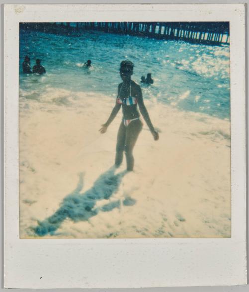 [Woman in bikini wading in body of water]
