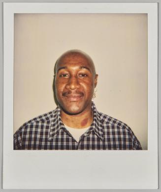 [Man wearing S-shape earring with birthmark on neck]
