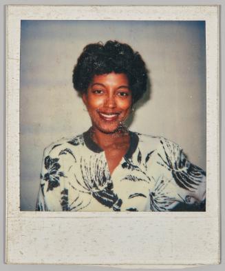 [Portrait of woman smiling in blue and white floral shirt]
