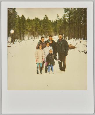 [Man, woman, teenage boy, and three children in forest landscape during wintertime]

