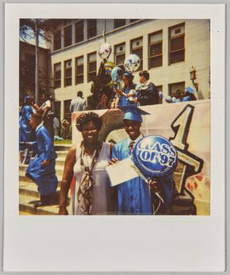 [Woman and teenage boy in graduation gown with class of '97 balloon]
