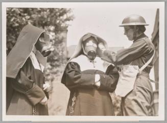 Nuns are given gas mask instructions by women wardens at St. Wilfred's Convent in Chelsea as part of a test.