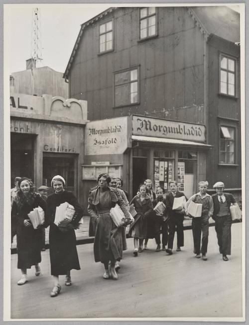 Early morning and the newspaper carriers prepare to deliver their newspapers.