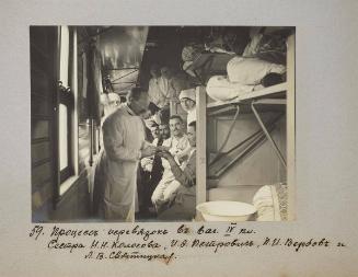 Process of bandaging in IV class car. Nurse N.N Kolosova, I.O Petrovih, P.I Verbov I L.V Svyatitskaia