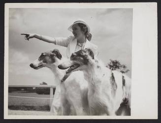 A woman with two dogs.