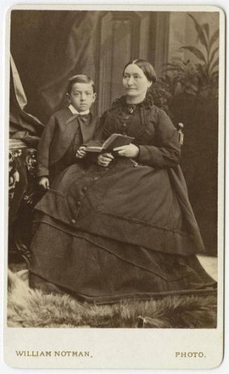 Woman and boy on fur rug