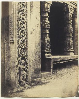 Madura. Pillars in the Recessed Portico in the Royal Gopurum with the base of one of the Four Sculpted Monoliths