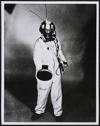 Nuclear worker in suit with Geiger counter