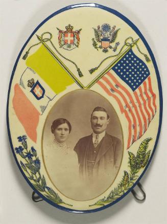 [Portrait of an immigrant couple, with national flags]