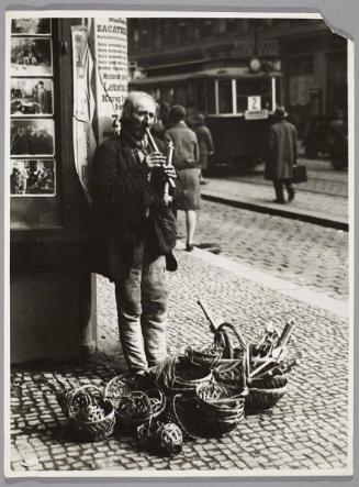 As the ground cannot nourish all the people in Slovakia, members of the male population have had to come up with other ways to feed their families. A man sells baskets and wooden musical instruments on the street corner in Prague.