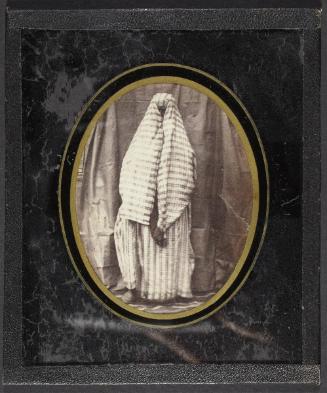 [Full-length portrait of figure in striped clothing, face covered]