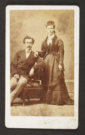 Unknown sitters [portrait of a seated man and standing woman, with her right hand on man's left shoulder]