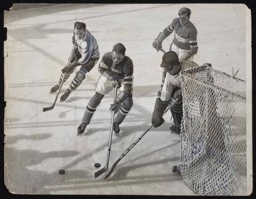 U.S. Hockey team loses to Canadians. Canada defeated the U.S., two goals to one, in an overtime match. The first hockey contest of the Winter Olympics at Lake Placid, NY.